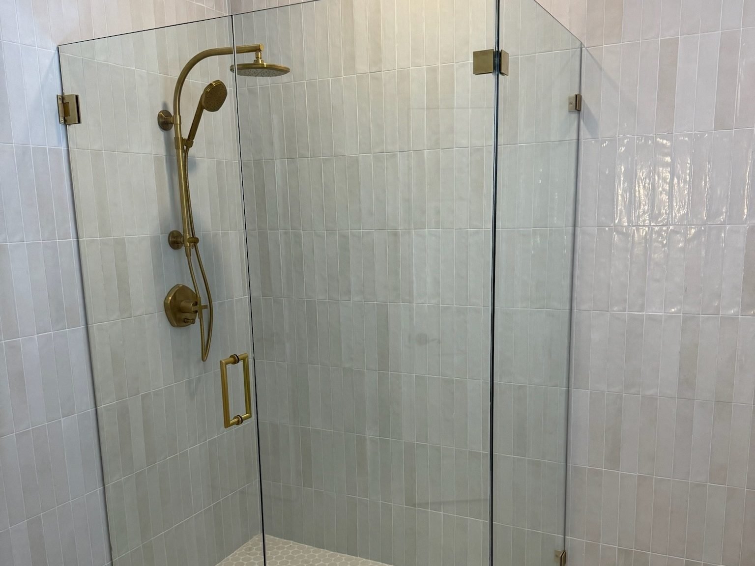 Bathroom gold shower white tile hexagon floor Holiday FL