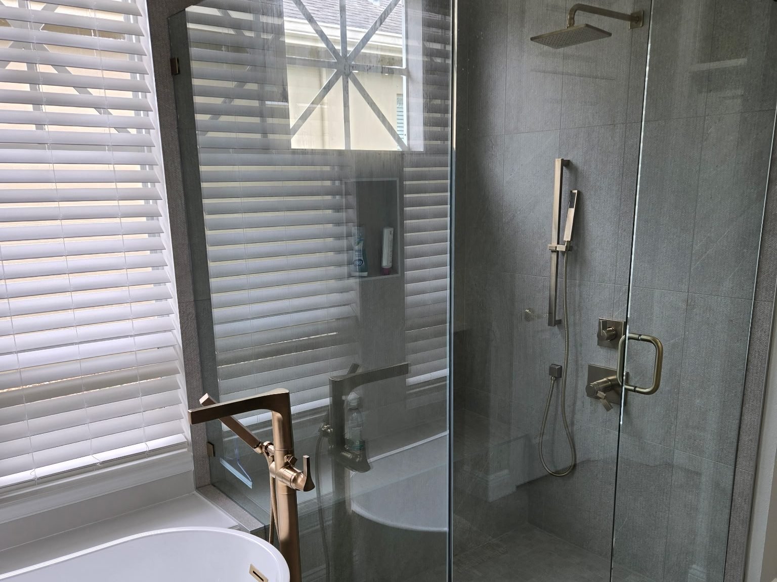 Bathroom gray tile freestanding tub glass shower Holiday FL