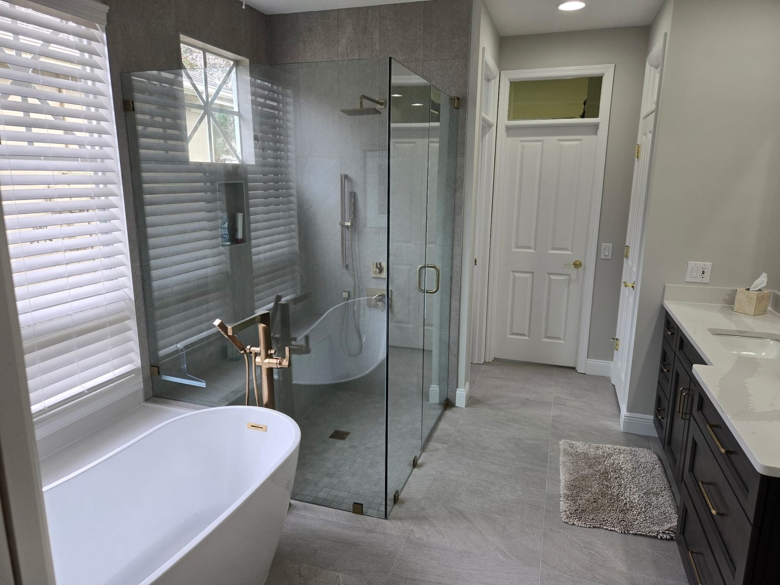 Bathroom gray tile wide vanity glass shower Holiday FL