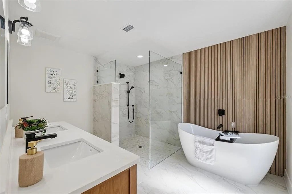 Bathroom marble wall freestanding tub gold chandelier Holiday FL