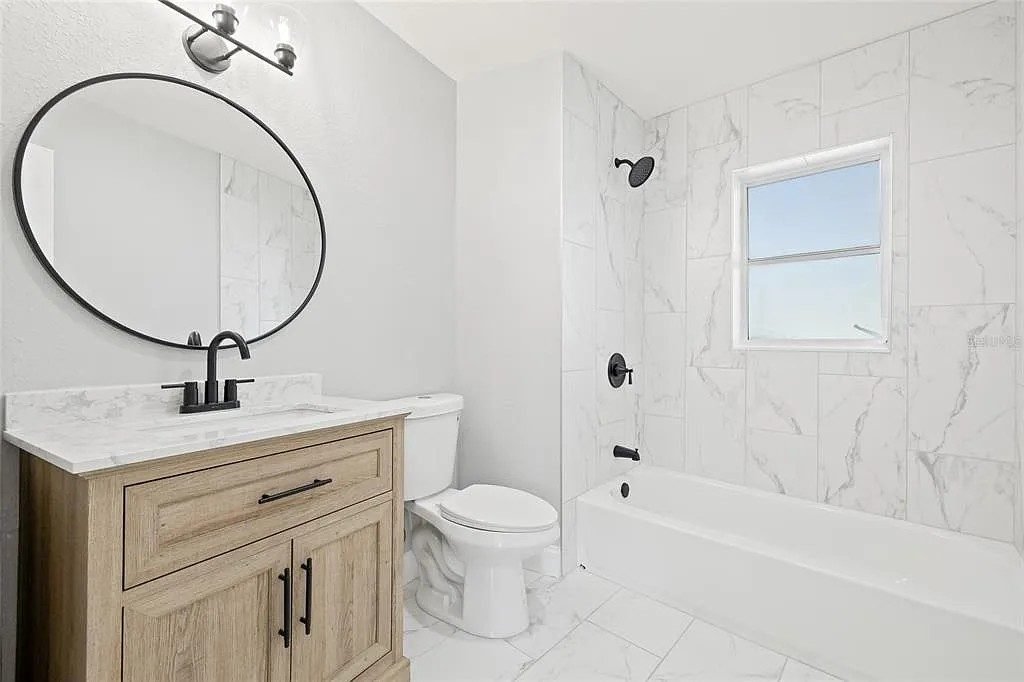 Bathroom white cabinets marble bath freestanding tub Holiday FL