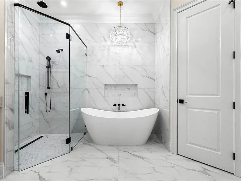 Bathroom white marble shower black hardware chandelier Holiday FL
