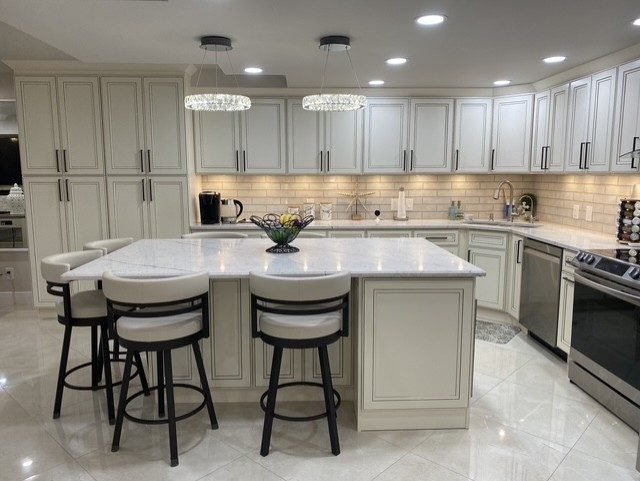 Ivory raised panel cabinets marble island kitchen Holiday FL