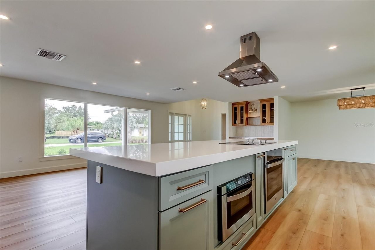 Sage green island with cooktop kitchen Holiday FL