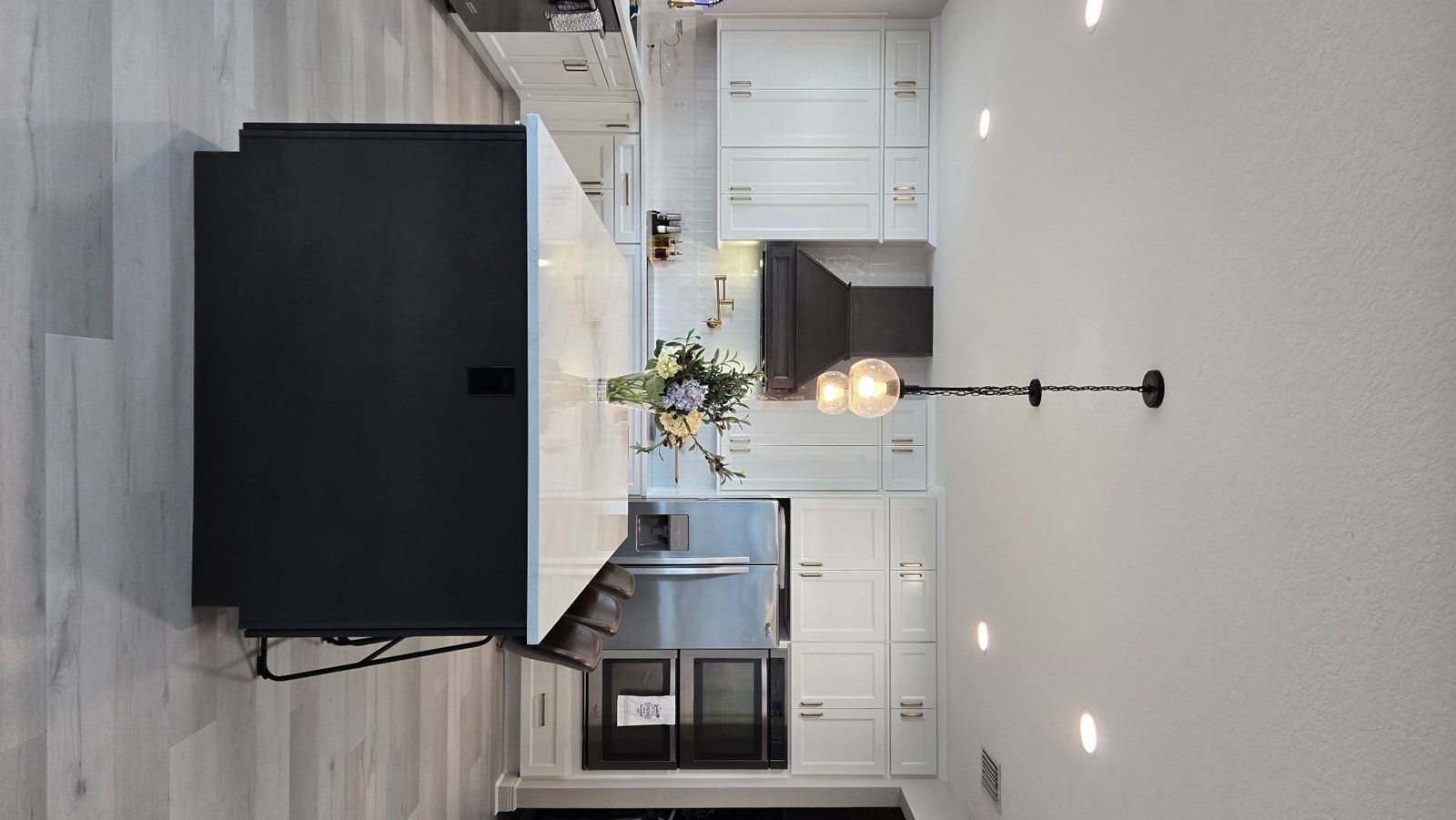 White kitchen black island wide view Holiday FL