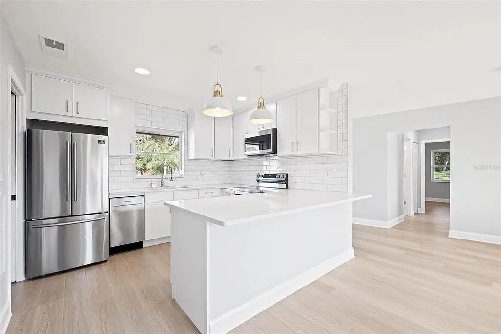 White kitchen island open plan wide view Holiday FL