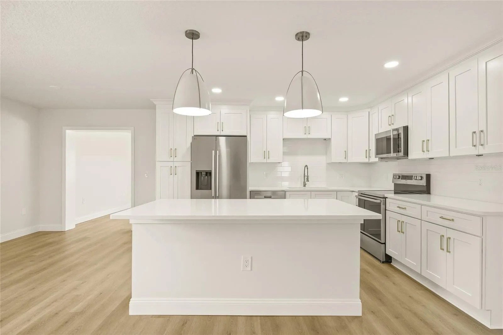 White open plan kitchen waterfall island Holiday FL