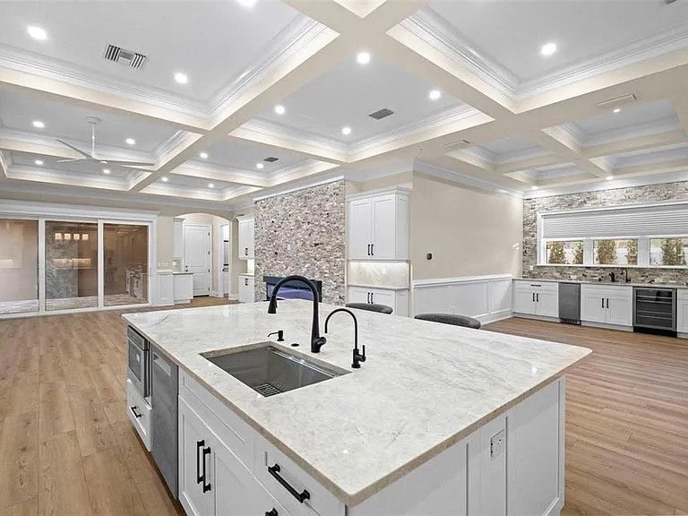 White shaker kitchen hood granite backsplash Holiday FL