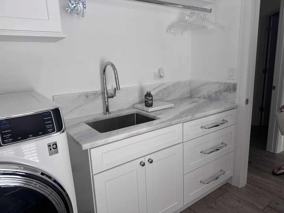 Laundry room stacked washer white cabinets Holiday FL