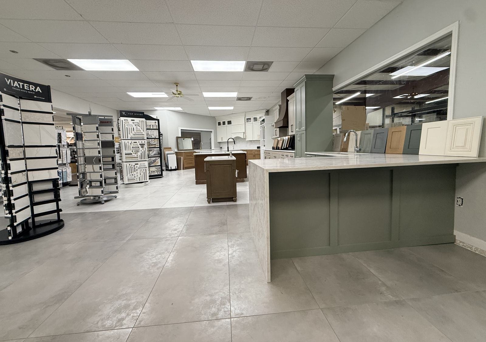 Carpet Corner Kitchen and Bath showroom with sage green counter, Fabuwood display, and flooring section, Holiday FL