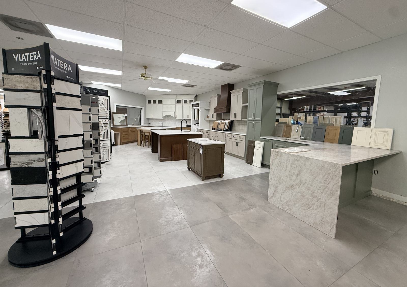 Carpet Corner Kitchen and Bath showroom floor with cabinet displays, Viatera and Top Knobs sample towers, Holiday FL