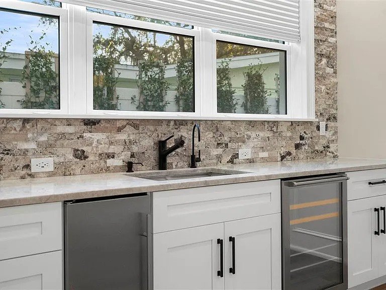 Wet bar white cabinets stone backsplash Holiday FL